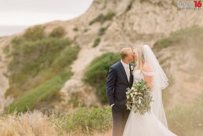 Bride and Groom share a sweet kiss near the beach in San Clemente