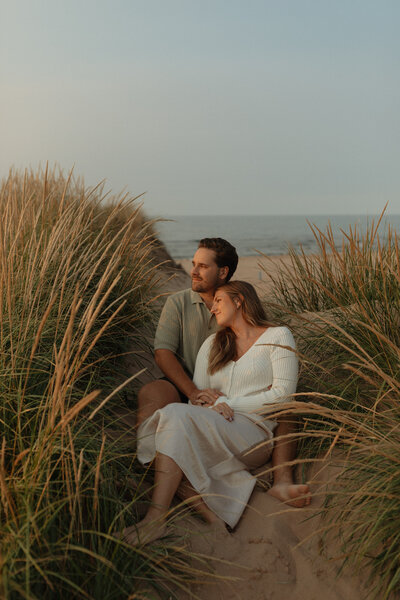 couple embrace on beach in prince edward island