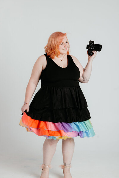 Melissa Cook, Leesburg VA Wedding Photographer, poses with a colorful dress and camera