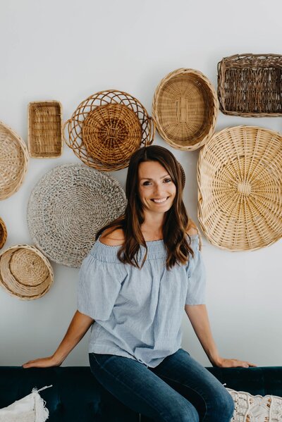 tracy-lingwai-in-front-of-basket-wall-smiling-at-camera