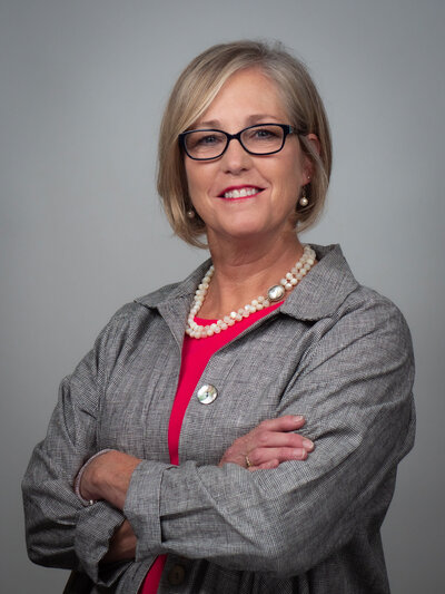 Corporate headshot makeup of female executive with glasses