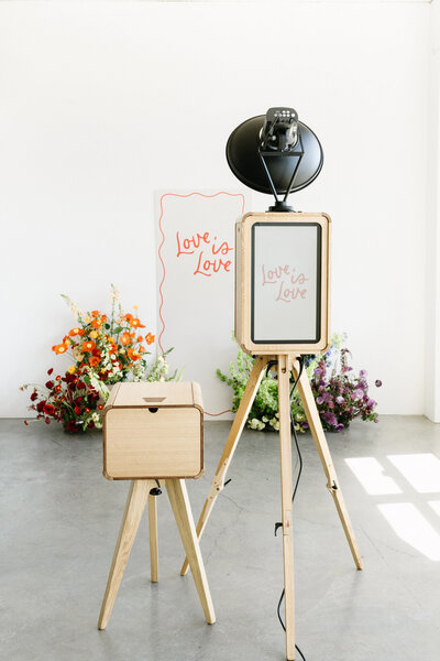 Love is Love event photo booth backdrop setup. Light and airy. Los Angeles luxury photo booth rental.