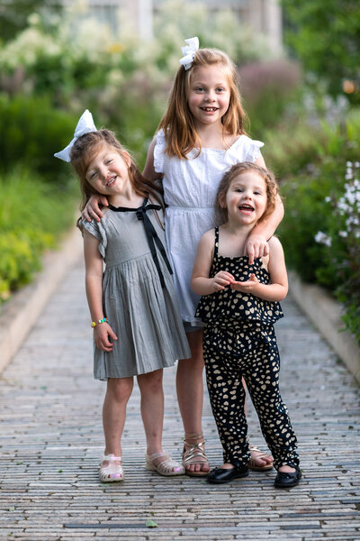 Kansas_City_Family_Photographer_girls_on_path_with_flowers-25