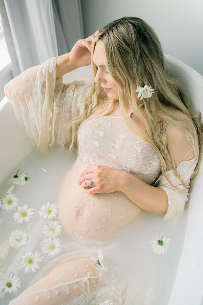maternity photos at home milk bath with flowers captured by utah maternity photographer