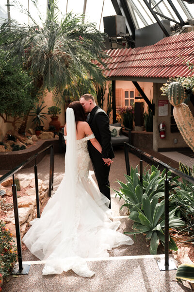 Bride and Groom kiss during wedding at the Muttart Conservatory in Edmonton, Alberta