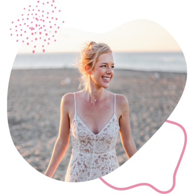 Blonde fair skinned woman on beach smiling looking to the side