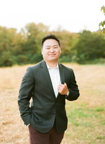 Male with white button down shirt and grey blazer