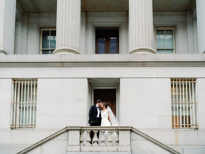 Bride and Groom Kiss in front of building in DC
