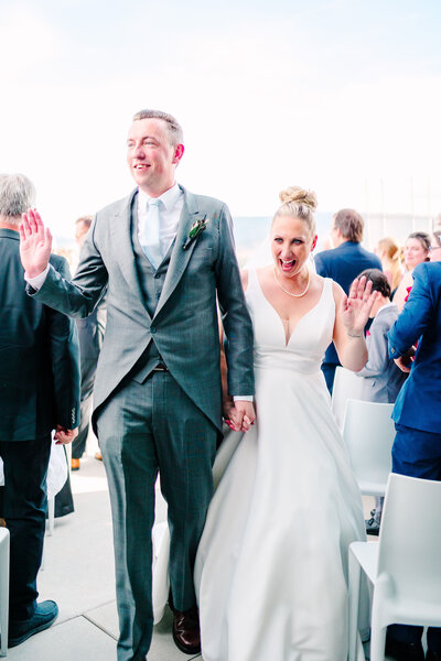 Bride and groom stand forehead to forehead and smile