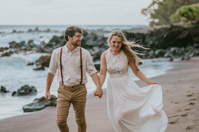 california elopement photography bride and groom walking on the beach