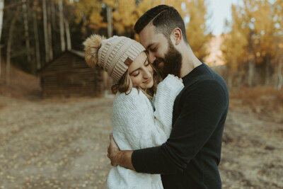 couple hugging during their fall engagement session in Breckenridge, Colorado.