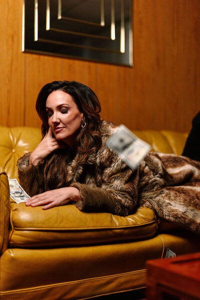 Photo of Juliet Trnka on a mustard yellow couch-Direct Knowing brand photo session