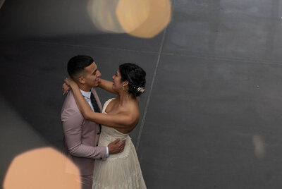 Young latino couple dancing in the Foundry's Main Space with bokeh effect taken by Latina Photographer, Patricia Parrales. photography Brooklyn.
