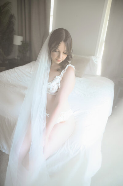 bridal boudoir with bride in wedding veil and wedding lingerie for bridal boudoir photography shoot in westminster maryland