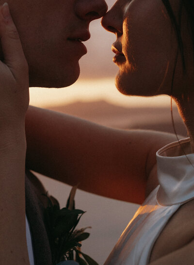 couple kissing in santorini greece
