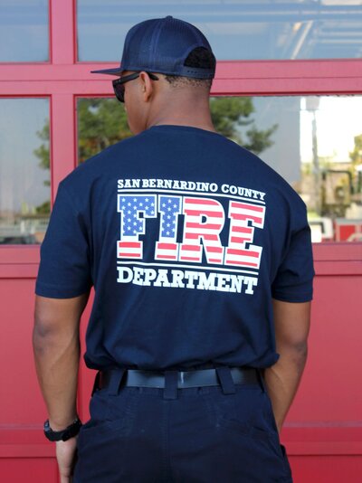 Screen printed firefighter t-shirt with a custom flag designed department logo