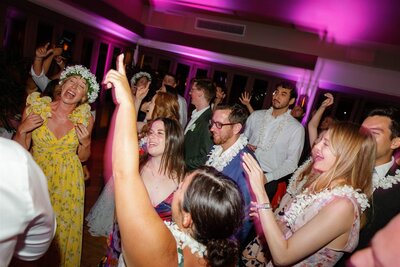 A wedding reception dance floor filled with wedding guests 