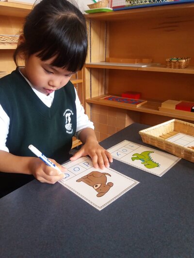 Stduent writing in a montessori classroom in Burnaby