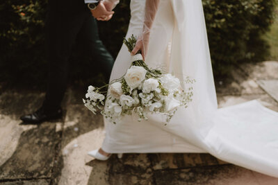 A bride carry a bouquet of flowers at Brinsop court