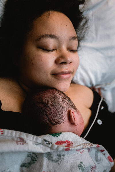 Mother holding newborn during peaceful skin-to-skin after birth at Fort Worth hospital — documented by DFW birth photographer.