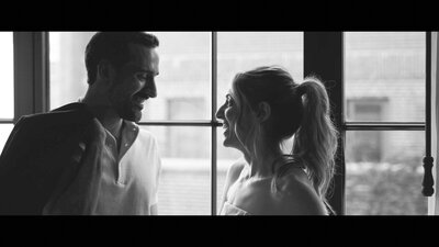A black and white photo of a bride and groom at the start of their New York City wedding day, capturing their anticipation and joy against the iconic urban backdrop.