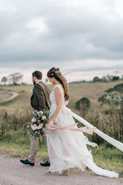 Bride and groom on a country road