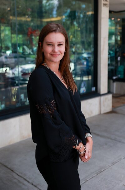 Videographer Lara wearing black and smiling at the camera