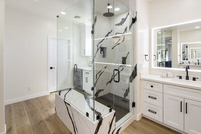 Marble shower with bench and double sided entrance.