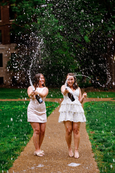 Two senior girls smiling and throwing anchor down signs