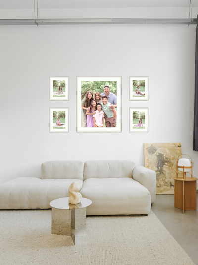 Family and newborn photographer in Utah with legacy wall art of the family and children in the living room.