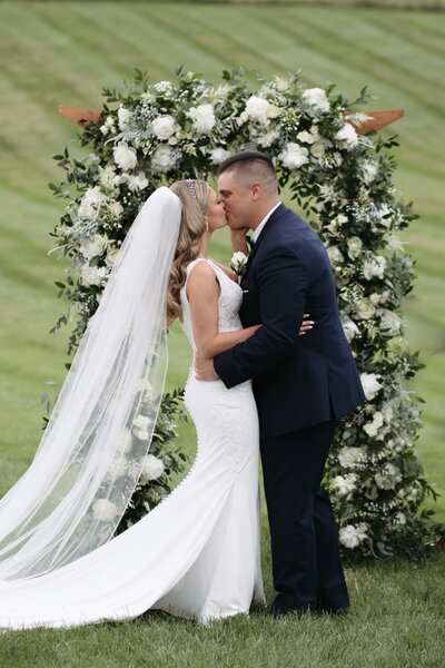 Elegant white floral wedding arch design by Just Bloom'd Weddings, Boston MA wedding florist.