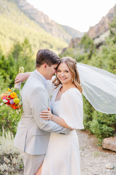 Bride and groom on their wedding day at Five Springs Campground in Lovell, Wyoming, with breathtaking mountain views as their backdrop.