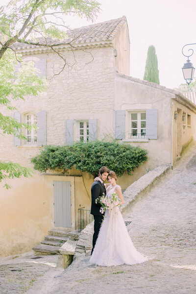 Charleston wedding couple portraits with a long sleeve lace wedding dress and petite bouquet