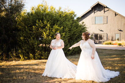 Rustic indoor wedding reception with white chairs and red table runners
