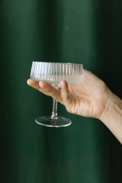 Chic coupe glass filled with champagne, symbolizing celebration and elegance.