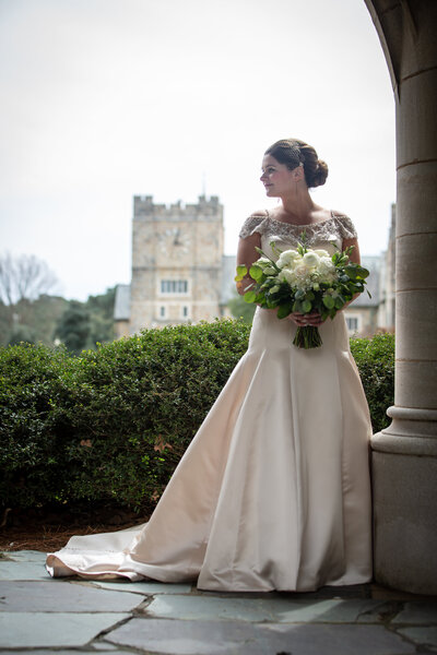 Bride Looking over shoulder in front of clock tower