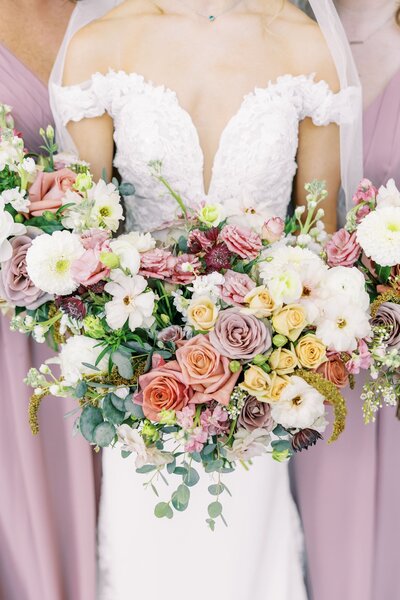 colorful bouquet of mauve, salmon, pink, white, and yellow