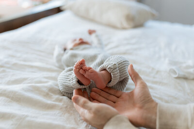 Newborn Photographer, a father admires his little baby
