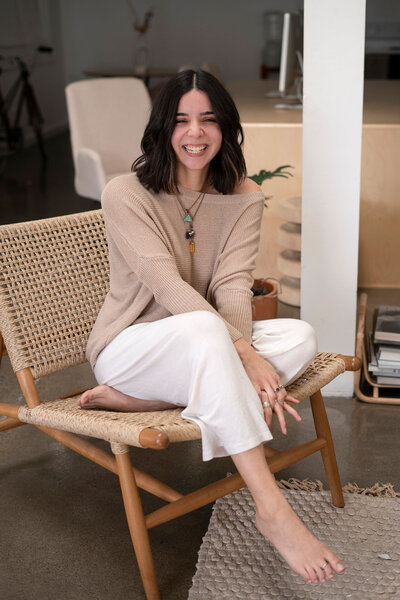 girl sitting on chair smiling at camera