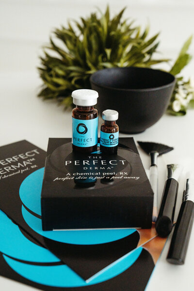 Professional skincare products for chemical peels displayed on a treatment tray with greenery