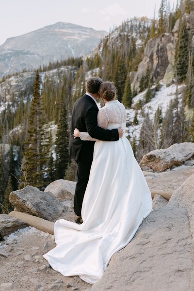 Colorado mountain elopement ceremony on rock formation — photographed while hiking in Rocky Mountain National Park.