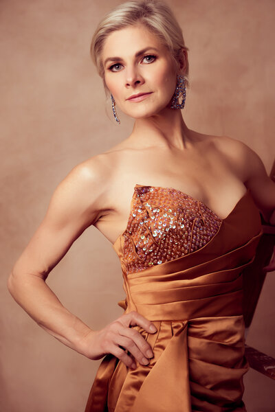 blond woman wearing a orange gown