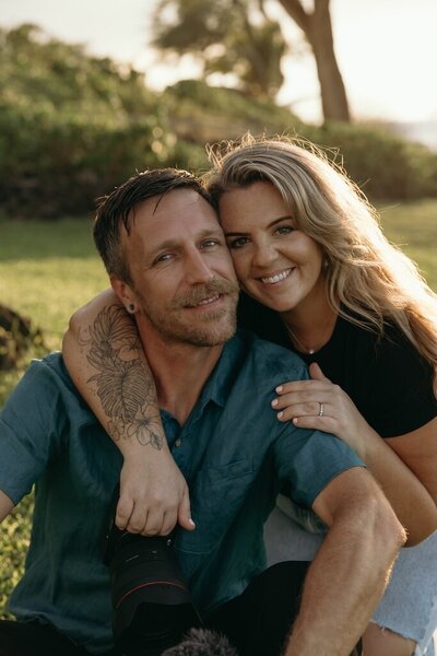 Maui Elopement Photographer captures woman holding camera while a couple elopes in Maui