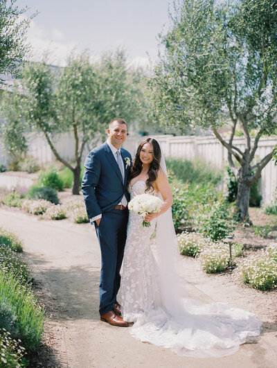 Bride and groom posing in front of the camera.