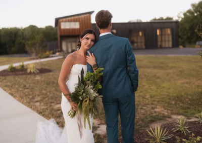 bride poses with bouquet of flowers before charlotte wedding