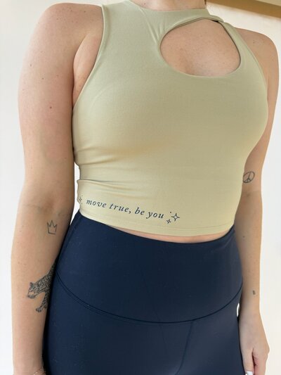 close up of "move true be you" detail on tan tank