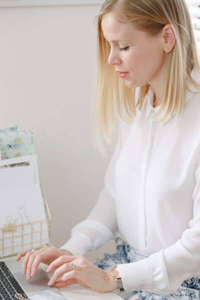 A female entrepreneur typing on a laptop keyboard