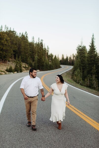 engagement session outside denver colorado, couple walking in the street