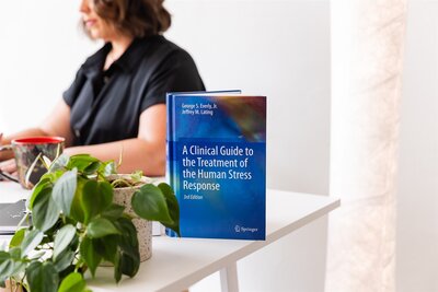 A close up of the book, "A Clinical Guide to the Treatment of the Human Stress Response"