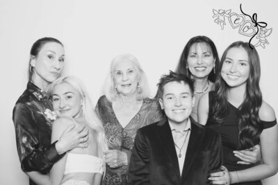 A group of people pose together and smile at the Birdie Photo Booth an Eugene Photo Booth rental.